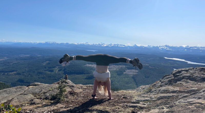 woman doing cartwheel on mountain